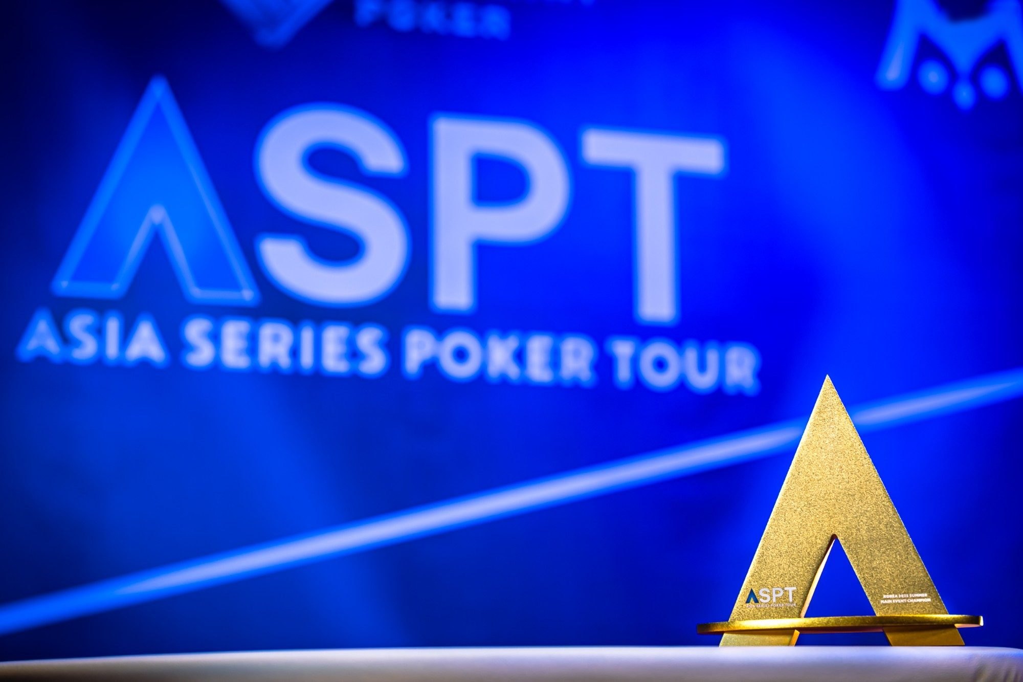 The ASPT Main Event trophy in front of the ASPT backdrop